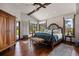 Comfortable main bedroom featuring a large bed, exposed ceiling beams, and lush golf course backyard views at 3216 Country Club Pkwy, Castle Rock, CO 80108