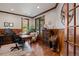 Home office with wood paneled walls, wood trim and floors, and lots of natural light at 3216 Country Club Pkwy, Castle Rock, CO 80108