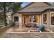 Inviting outdoor patio space with comfortable seating and a cozy stone fire pit with beautiful outdoor views at 3216 Country Club Pkwy, Castle Rock, CO 80108
