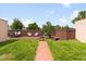 Spacious backyard featuring a deck, lush lawn, and brick pathway at 3739 W 46Th Ave, Denver, CO 80211