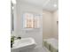 Updated bathroom featuring tiled shower, beadboard accent, and vanity sink at 3739 W 46Th Ave, Denver, CO 80211