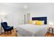 Cozy bedroom with a bed, blue accent chair, and ample natural light at 3739 W 46Th Ave, Denver, CO 80211