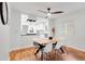Open-concept dining area flows into a modern kitchen, featuring hardwood floors and sleek lighting at 3739 W 46Th Ave, Denver, CO 80211
