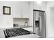 Well-equipped kitchen features stainless steel appliances, a gas cooktop, and stylish white cabinetry at 3739 W 46Th Ave, Denver, CO 80211
