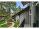Private balcony overlooking a serene courtyard with lush greenery and mature trees at 2378 Hearth Dr # 20, Evergreen, CO 80439
