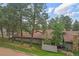 Two-story home with beautiful trees, fenced patio, and stone chimney at 2378 Hearth Dr # 20, Evergreen, CO 80439