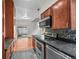 Open concept kitchen with stainless steel appliances, stone countertops, and seamless access to living area at 2378 Hearth Dr # 20, Evergreen, CO 80439