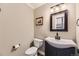 A quaint bathroom features modern fixtures, a dark vanity, and a sleek mirror, offering comfort and style at 7273 E Hinsdale Pl, Centennial, CO 80112