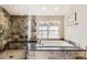 Bathroom featuring stone tile shower, soaking tub, and natural light from large window at 7273 E Hinsdale Pl, Centennial, CO 80112