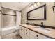 Bathroom featuring double sinks, updated fixtures, and a tiled shower and tub combination at 7273 E Hinsdale Pl, Centennial, CO 80112