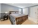 Bedroom with wood-framed bed, wainscotting, neutral carpet, and dual closets at 7273 E Hinsdale Pl, Centennial, CO 80112