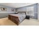 Cozy bedroom with blue walls, wood trim and a comfortable bed with patterned linens at 7273 E Hinsdale Pl, Centennial, CO 80112