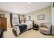 Bedroom with a chair, neutral carpet, window, closet and wooden framed bed at 7273 E Hinsdale Pl, Centennial, CO 80112