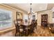 This home has a formal dining room with hardwood floors, designer paint, and ample natural light through a set of windows at 7273 E Hinsdale Pl, Centennial, CO 80112