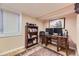 Home office features a wooden desk and bookshelf, hardwood floors, and plenty of natural light at 7273 E Hinsdale Pl, Centennial, CO 80112