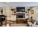 Inviting living room boasts built-in shelving, a fireplace, and a grand piano at 7273 E Hinsdale Pl, Centennial, CO 80112