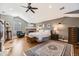 Spacious main bedroom features hardwood floors, a brick fireplace, a ceiling fan, and a sitting area offering relaxation and style at 7273 E Hinsdale Pl, Centennial, CO 80112