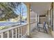 Cozy covered porch with outdoor seating, offering a relaxing view of the neighborhood street at 7273 E Hinsdale Pl, Centennial, CO 80112