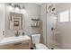 Bright bathroom featuring modern vanity, decorative tile, and a glass shower at 10810 W Alamo Pl, Littleton, CO 80127