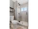 Modern bathroom featuring a glass shower enclosure with white tile and updated fixtures at 10810 W Alamo Pl, Littleton, CO 80127