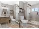 Neutral-toned bathroom with modern vanity, decorative tile flooring, and glass-enclosed shower at 10810 W Alamo Pl, Littleton, CO 80127