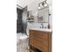 Contemporary bathroom featuring dark gray tiles and a wooden vanity with black hardware at 10810 W Alamo Pl, Littleton, CO 80127