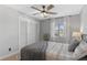 Bedroom with a queen-sized bed, wooden ceiling fan, and a double door closet at 10810 W Alamo Pl, Littleton, CO 80127