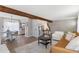 Inviting living room with open floor plan, fireplace, wooden beam, and comfortable seating area at 10810 W Alamo Pl, Littleton, CO 80127