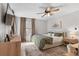 Comfortable main bedroom with a ceiling fan, soft rug, and coordinating bedside tables at 10810 W Alamo Pl, Littleton, CO 80127