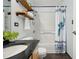 Bathroom featuring modern vanity, shower and bath, and rustic shelving at 444 17Th St # 208, Denver, CO 80202