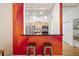 Kitchen bar with seating, open view to kitchen with stainless steel appliances, and decorative painting at 444 17Th St # 208, Denver, CO 80202