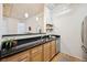 Kitchen features wood cabinets, black countertops, stainless steel appliances, and hardwood flooring at 444 17Th St # 208, Denver, CO 80202