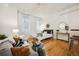 Living room area with couch, coffee table, rug, art, bedroom area, hardwood floors, and industrial ceiling at 444 17Th St # 208, Denver, CO 80202