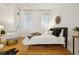 Bright main bedroom with hardwood floors, minimalist decor, and bright natural light at 444 17Th St # 208, Denver, CO 80202