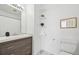 Bathroom with a modern vanity, toilet, shower curtain, decorative shelves, and vanity lighting at 9770 Dahlia Ln, Thornton, CO 80229