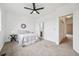 Neutral bedroom with a ceiling fan, carpet, white walls, and multiple closets at 9770 Dahlia Ln, Thornton, CO 80229