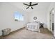 Bright bedroom with a ceiling fan, large window, neutral carpet, and white walls at 9770 Dahlia Ln, Thornton, CO 80229