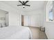 Spacious bedroom featuring a ceiling fan, white walls, carpet, and a set of closet doors at 9770 Dahlia Ln, Thornton, CO 80229