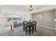 Upstairs dining area with modern lighting, a four-person table, and an open layout at 9770 Dahlia Ln, Thornton, CO 80229