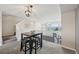 Cozy dining area with stylish lighting, a four-person table, and views from the large windows at 9770 Dahlia Ln, Thornton, CO 80229