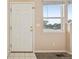 Bright entryway featuring a white front door and a window offering a glimpse of the outdoors at 9770 Dahlia Ln, Thornton, CO 80229