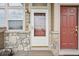 Close up of the front door featuring stone accents, and the house number at 9770 Dahlia Ln, Thornton, CO 80229