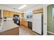 Well-lit kitchen with light wood cabinets, modern appliances, and laminate flooring at 9770 Dahlia Ln, Thornton, CO 80229