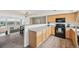 Open kitchen and dining area with light wood cabinets and modern appliances at 9770 Dahlia Ln, Thornton, CO 80229