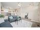 Bright living room featuring neutral colors, comfortable seating, and easy access to the staircase at 9770 Dahlia Ln, Thornton, CO 80229
