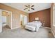 Spacious main bedroom with a ceiling fan, carpet, and large window with neighborhood views at 9770 Dahlia Ln, Thornton, CO 80229