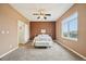 Inviting main bedroom with neutral walls, carpet, a ceiling fan, and a large window at 9770 Dahlia Ln, Thornton, CO 80229
