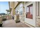 Welcoming front porch with stone accents and a view of neighboring townhomes at 9770 Dahlia Ln, Thornton, CO 80229