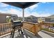 Outdoor deck featuring a grill with views of neighboring homes on a bright, sunny day at 4851 Cattle Cross Rd, Castle Rock, CO 80104