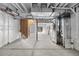Unfinished basement with high ceilings, framed walls, and utility hookups at 4851 Cattle Cross Rd, Castle Rock, CO 80104